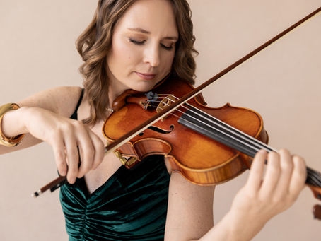 Woman playing the violin with serene look