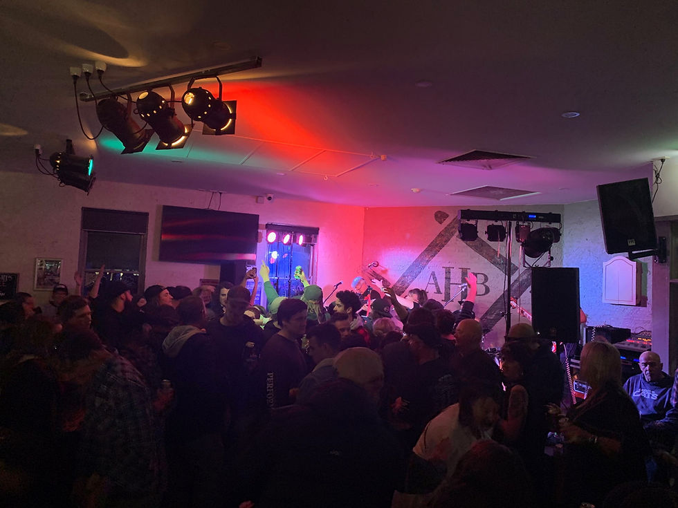 Crowded music event with people dancing and colorful lights Alpine Hotel Bright Rod Run