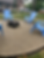 firepit inside gravel circle with beach chairs located on side yard