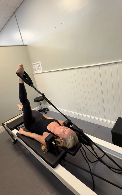 me on reformer machine.jpg