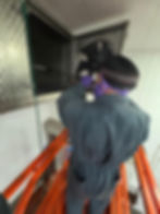Technician cleaning industrial fan for gallery display