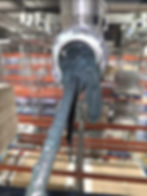 Industrial machine pouring thick grey paste in a gallery