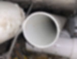 Close-up of white PVC plumbing pipes in a gallery gallery