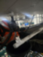 Worker servicing piping in an industrial gallery.