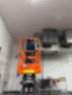 Worker on a lift in a project gallery