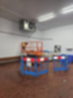 Orange scissor lift in a cold storage gallery