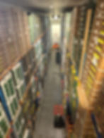 Tall stacked crates in a warehouse storage gallery.