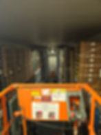Warehouse gallery showing boxes organized on high shelves
