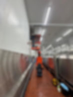 Worker in lift at industrial facility gallery