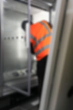 Worker in safety vest inspecting gallery display case
