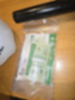Small clear bag with bio-cleaning items in a gallery.