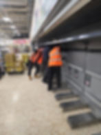 Workers in high-visibility vests fixing a store gallery