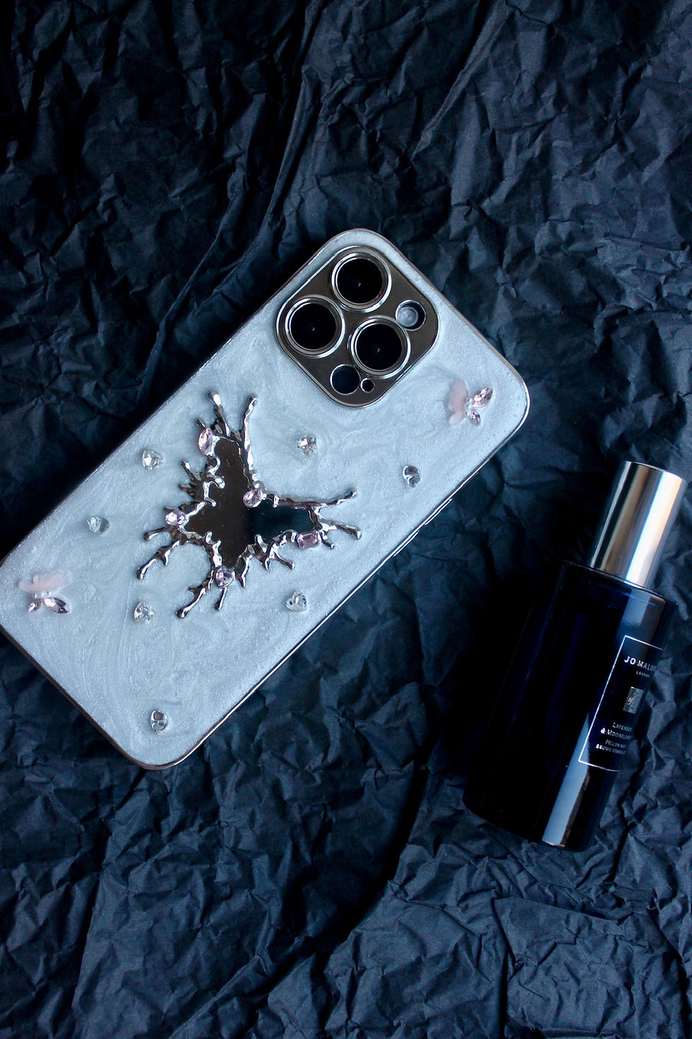 Elegant silver phone case with 3D butterfly design and crystal accents