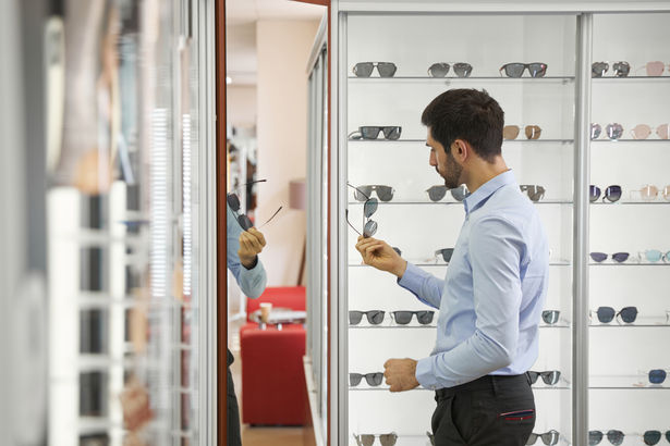 6-man-studying-sunglasses-in-showroom-of-optician-sh-2026-01-09-01-09-40-utc.jpg