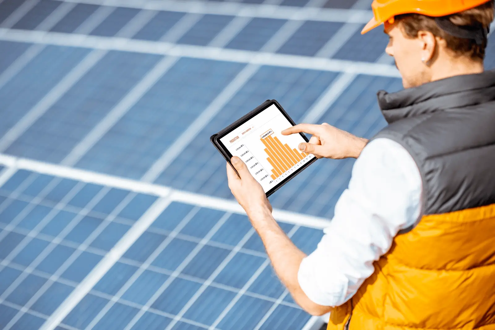 two people discussing commercial solar panels installation while crouching on rooftop