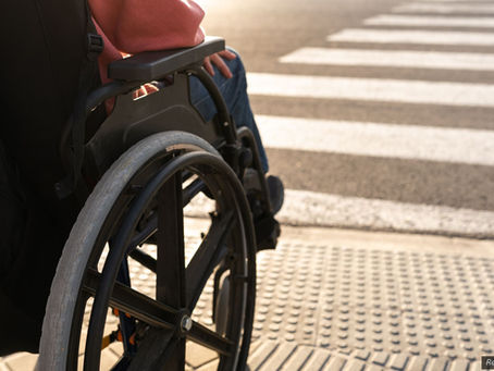Person using a wheelchair crossing a street at a crosswalk in an illustrative image related to a Santa Rosa hit-and-run collision article.