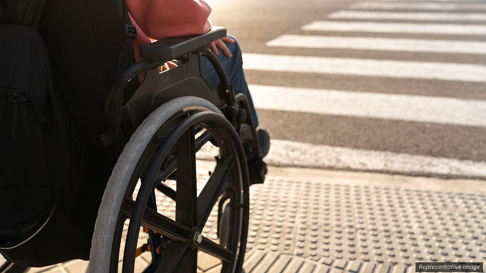 Person using a wheelchair crossing a street at a crosswalk in an illustrative image related to a Santa Rosa hit-and-run collision article.