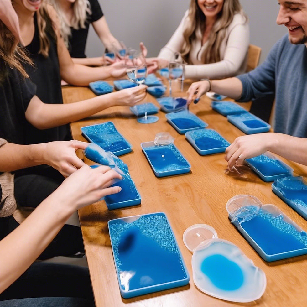 Friends are laughing as they pour colored resin blue in a silicone mold. This is landscape