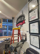 ladder next to mural of a logo