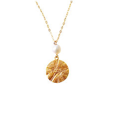 My design is inspired by living on the coast of South Australia and Marine Conservation. The pendant is made of Fine Silver and is Gold Plated with 18ct Yellow Gold. The pendant is an imprint from a Sea Star. The necklace has a 7mm Freshwater Pearl and hangs on a Gold Filled Chain.