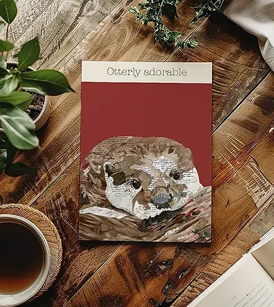 'Otterly adorable' art print placed onto a wooden table