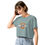 Thumbnail: Young woman wearing a teal crop top with an emblem and a feddo.