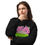 Thumbnail: Woman wearing black sweatshirt with graffiti text, thinking, light background.