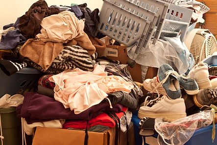Pile of misc items stored in an unorganized fashion in a room.jpg