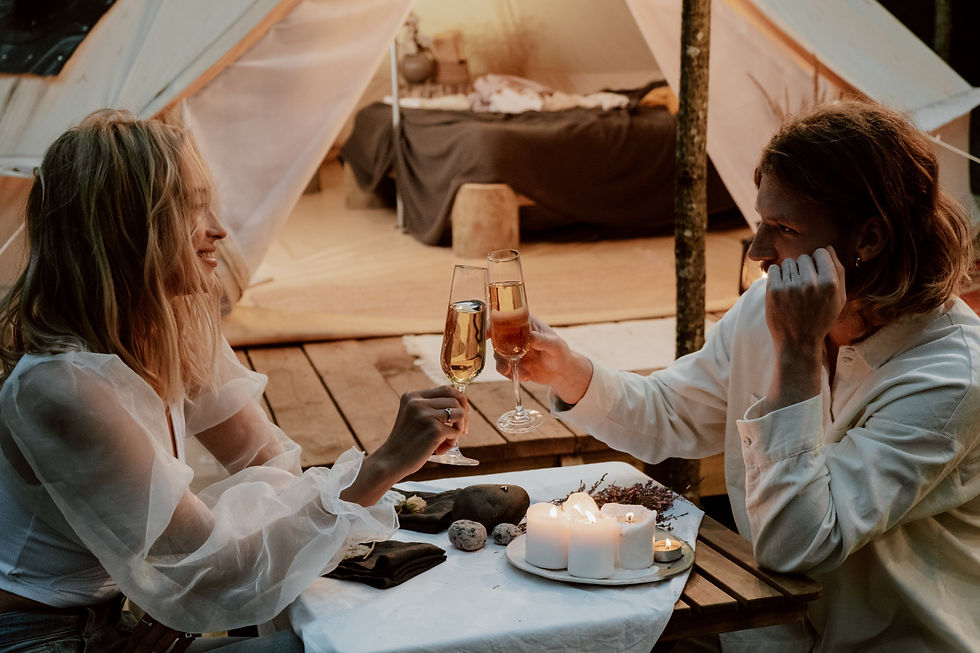 Couple dining outside of their glampsite.