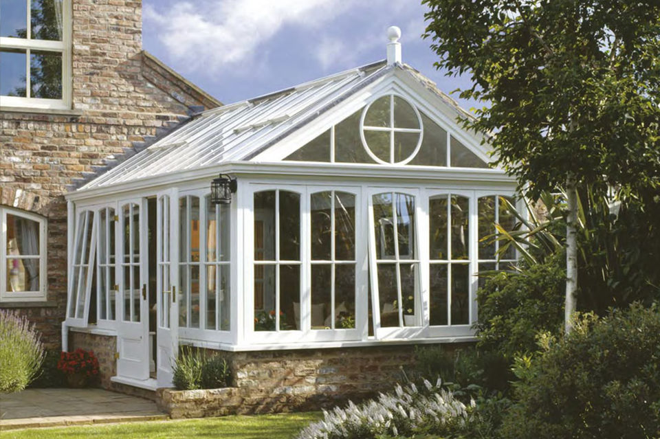 Traditional hardwood conservatory with pitched roof and heritage detailing