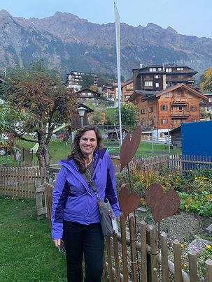 Jodi Wooten and her husband overlooking a scenic mountain village in Switzerland.