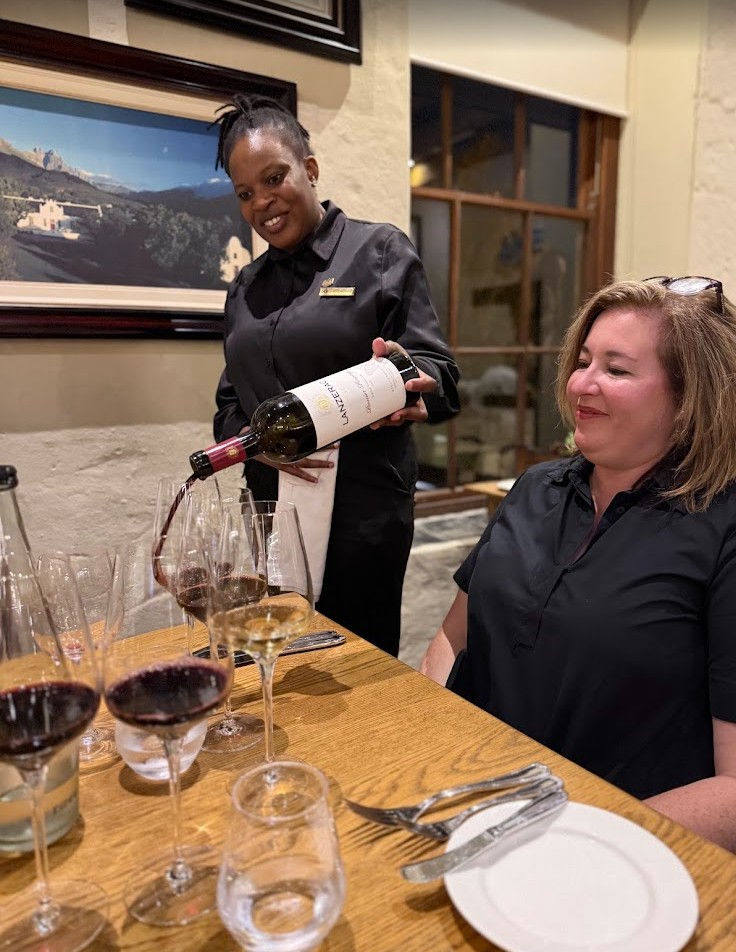 Sommelier pouring South African Pinotage during a wine tasting at Lanzerac Wine Estate in South Africa wine country.