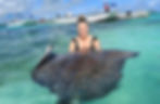 Travel agent Jennifer holding a sting ray in Antigua