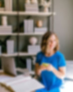Travel agent smiling while working from a home office on a laptop