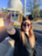 Travel agent holding a Disney World Annual Pass after building a successful travel business