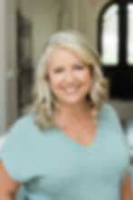 Jennifer is smiling because she is a succesful travel agent and agency owner
