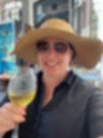 Travel agent having a glass of wine in Greece after building a successful travel business