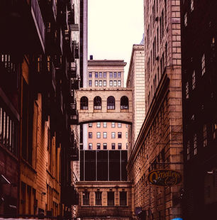 Urban alley in Pendleton Cincinnati with overhead skywalk between historic brick buildings