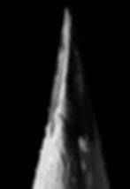 Extreme macro photograph of a pencil point photographed in black and white. The graphite and wood in the pencil has lots of detail.