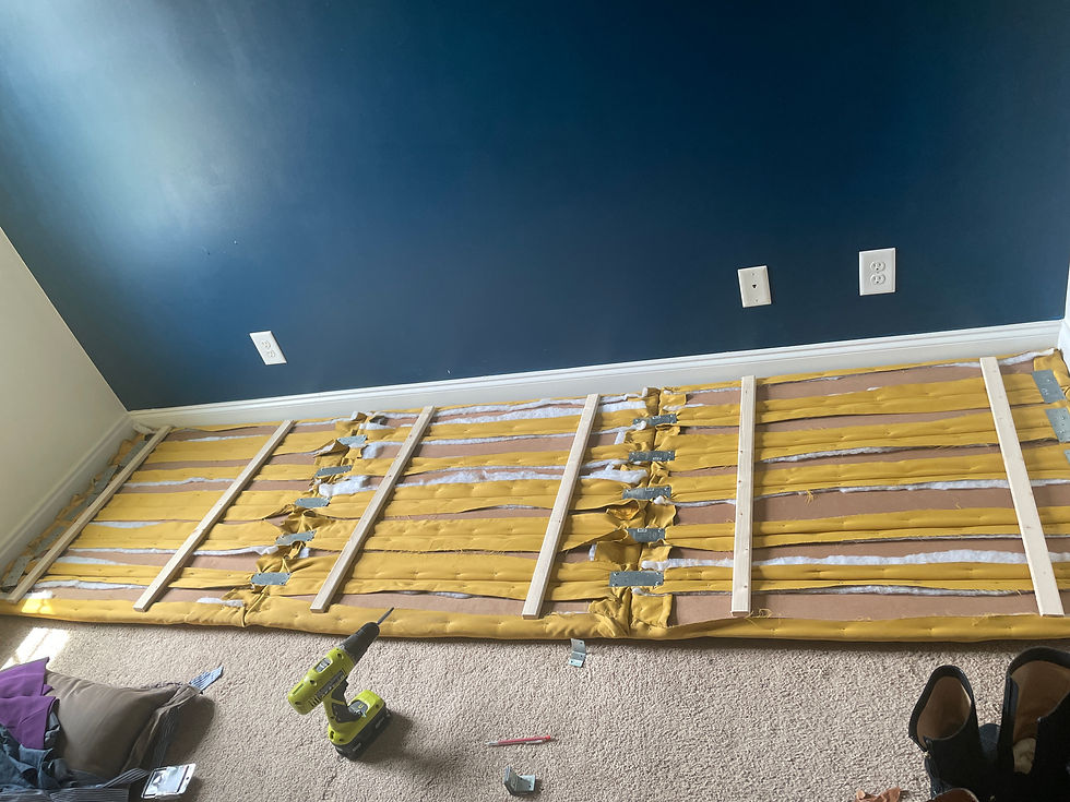 Backside of the headboard feature, showing the stapled sides, tie strap attachments and furring strips.