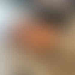 Wooden herringbone table top stained a pecan color and frame pieces painted black.