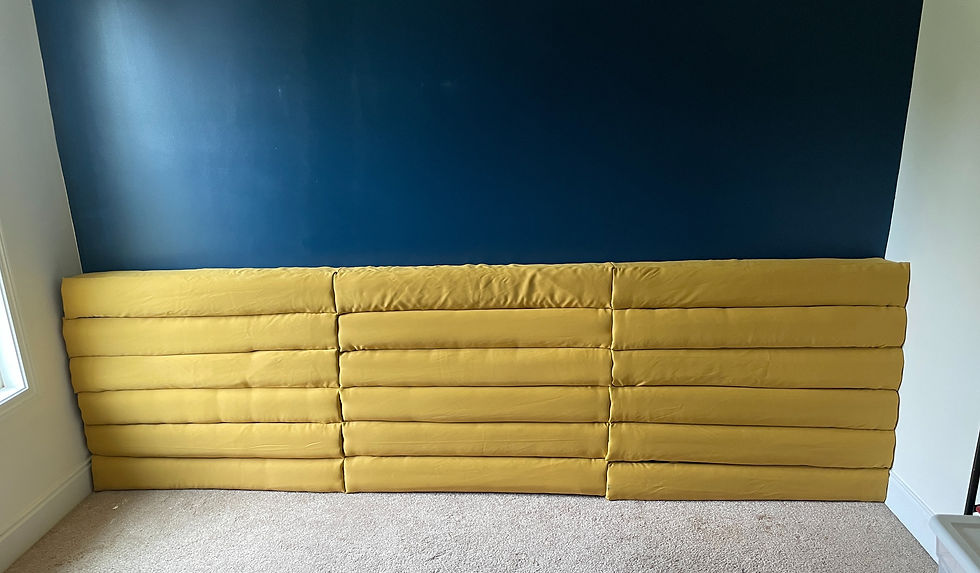 Upholstered headboard feature spanning the width of the wall, almost 3 feet tall.