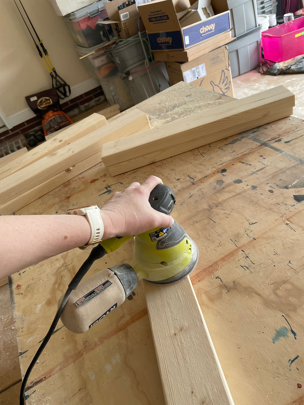Orbital palm sander being used to smooth the raw lumber.