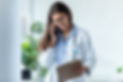 pretty-female-doctor-talking-on-mobile-phone-while-ZLSPG25.jpg