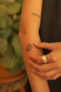 Delicate berry tattoo in very fine line and dotwork on the forearm – subtle black ink by Vangotattoo in Algarve, sagres