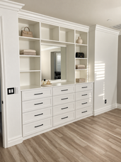 White built-in dresser with drawers, open shelves and a mirror