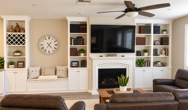 White living room built-ins around a TV and fireplace