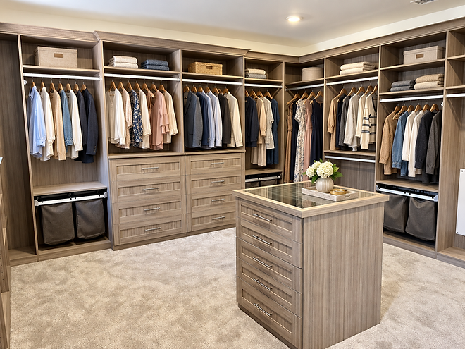 Textured woodgrain custom walk-in closet with a center island