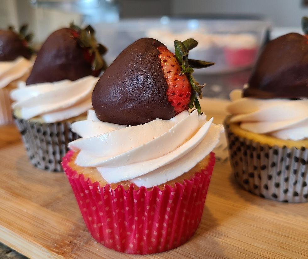 Vanilla Cupcakes with a chocolate covered strawberry on top