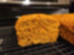 A carrot and apple loaf cut open showing the moist bread like interior